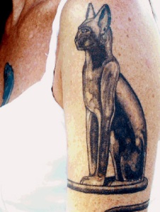 Bast — Egyptian goddess and protector of felines, adoring Kim's arm